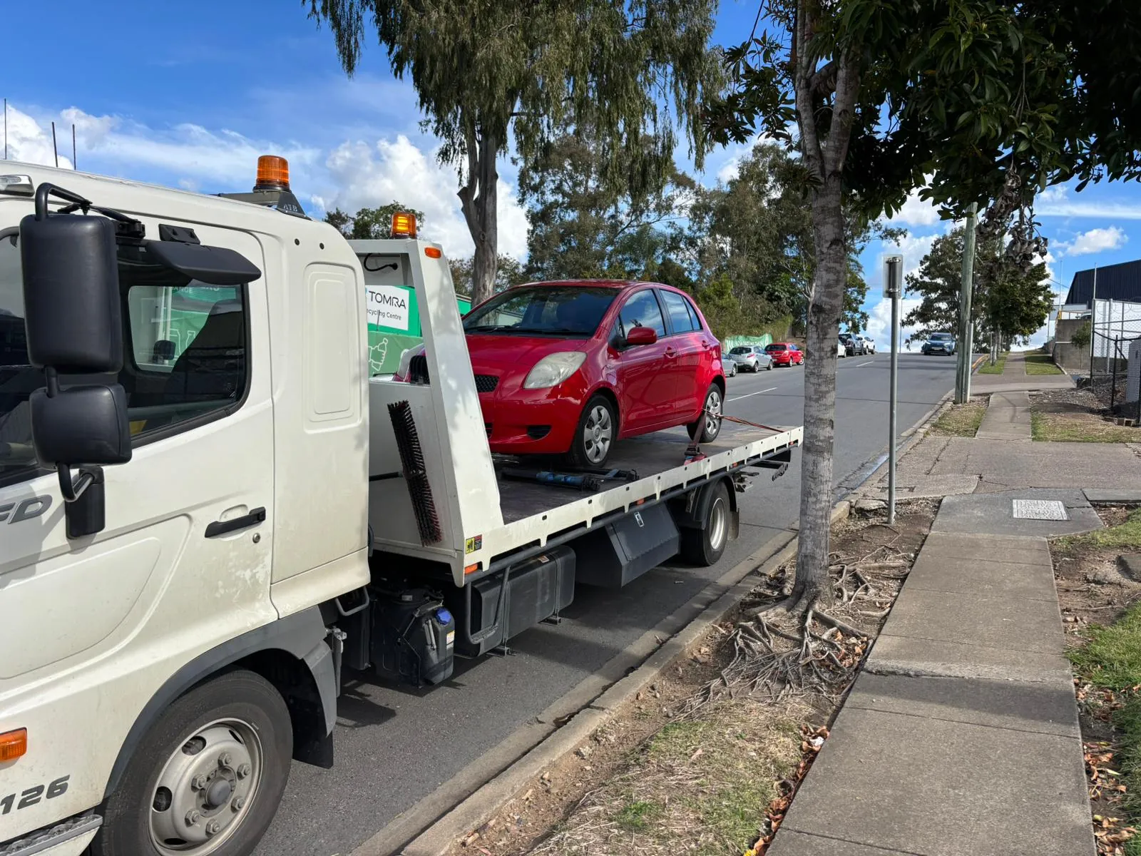 Our flatbed tow truck collecting a car for same-day removal in Brisbane.
